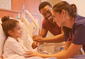 Child in hospital with father and nurse